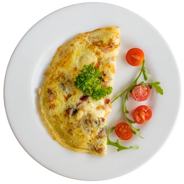 A golden omelet with bacon and mushrooms, garnished with parsley, cherry tomatoes, and arugula.